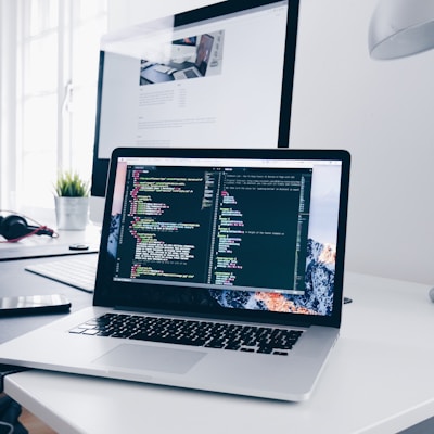 Developer workspace with laptop and code